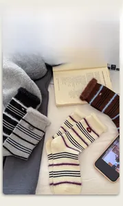 Detail of warm striped mink velvet socks with plush trim and decorative egg fabric label