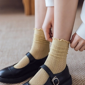 Ginger yellow hollow lace mesh socks with ruffled cuffs worn with Mary Jane shoes