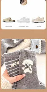 Detail of gray wool socks featuring cute 3D puppy patch and decorative bow accents