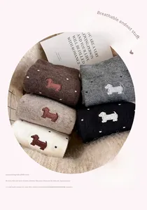 Detail of five colors cashmere socks with embroidered dachshund dog and white polka dots