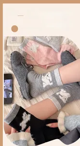 Detail of wool-blend mid-tube socks featuring cute 3D cartoon dog embroidery patterns