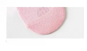 Macro detail of seamless hand-linked toe stitching on pink breathable cotton socks