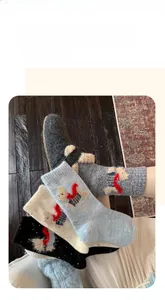 Close-up of thick wool socks featuring plush cartoon puppy with red scarf detail