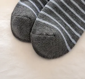 Detailed close-up of reinforced toe seam on striped wool blend socks for extra durability