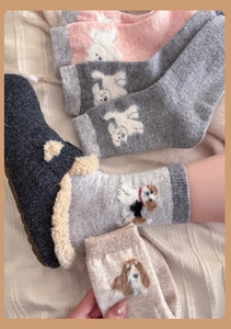 Close-up of thick wool socks with 3D cartoon puppy pattern and warm plush lining