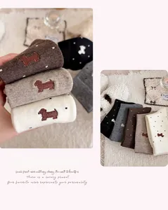 Detailed view of thick cashmere socks with cute dog embroidery and white polka dots
