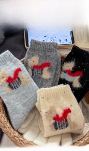 Detail of wool socks in four colors with 3D cartoon dog embroidery and colorful dots