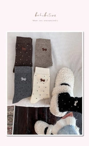 Detail of cute dachshund embroidery and white polka dots on cozy cashmere socks