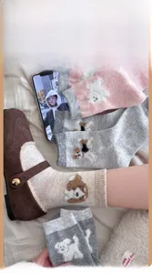 Detailed view of thick wool socks with cartoon dog patches paired with suede shoes