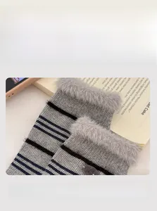 Detail of warm striped mink velvet socks with plush fur trim and elastic cuffs