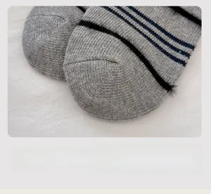 Close-up of gray knit socks with flat seam toe and soft mink velvet stripes