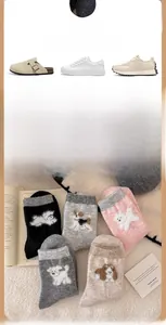 Close-up of thick wool socks with cute dog embroidery in five soft pastel colors