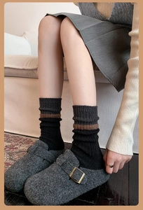 Close-up of wool blend striped socks paired with dark grey felt clogs for winter