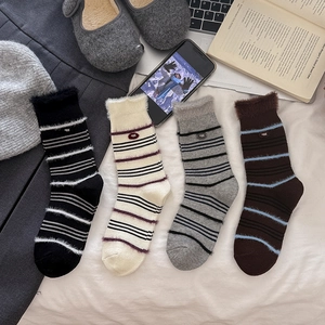 Four pairs of warm mink velvet crew socks with stripe patterns and decorative egg labels