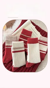 Detail of striped cashmere socks in red and cream showing rib knit texture and warmth