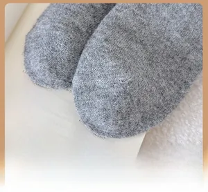 Close-up of reinforced toe detail on thick grey wool socks with premium knit texture
