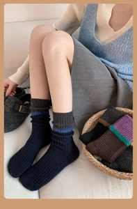 Detailed knit texture of wool-blend ribbed socks in blue and grey color block style