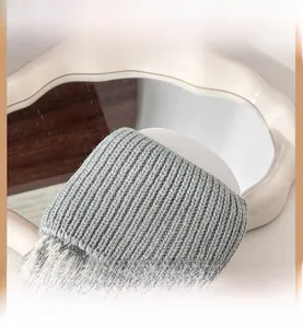 Close-up of elastic ribbed cuffs on grey knit leg warmers for a snug ankle fit