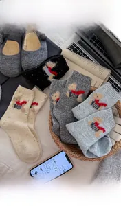 Close-up of speckled wool socks with cute puppy scarf embroidery in assorted colors