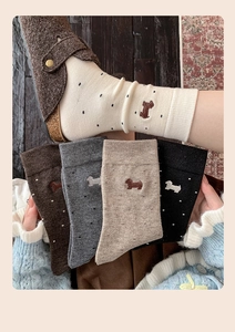 Detail showing five pairs of warm cashmere socks with cute dog embroidery and polka dots