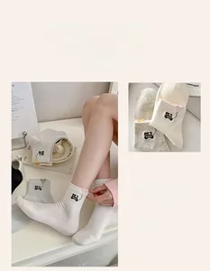 Detailed embroidery of cartoon cat and 3D heart on pastel ribbed cotton socks