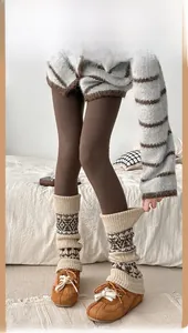 Close-up of vintage Fair Isle knit leg warmers paired with brown suede shoes and tights