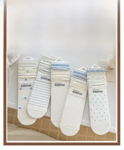 Detail of five-pack crew socks set featuring light blue polka dots and stripes