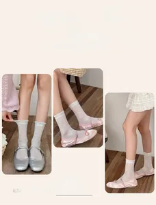 Detail of sheer mesh silk socks with heart patterns and ruffle cuffs in ballet style