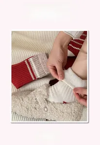 Close-up of striped cashmere socks and plush faux fur slippers with buckle detail