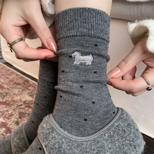 Gray cashmere blend socks with polka dots and puppy embroidery shown in cozy home setting