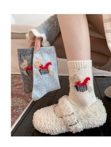 Close-up of winter wool socks featuring cute 3D cartoon puppy motifs and colorful flecks
