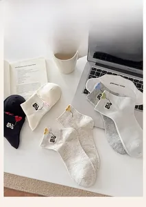 Detail of cotton socks with cat embroidery and heart pattern in soft lifestyle setting