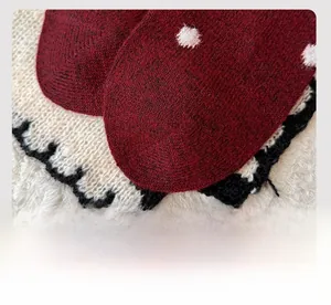 Detail of burgundy wool socks showing fine knit texture and flat toe seam craftsmanship