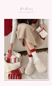 Close-up of red and white striped cashmere socks with thick knit texture for winter comfort