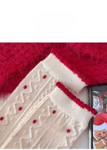 Nahaufnahme von Wollsocken mit roter Schleife, Wellenmuster und Rüschenbündchen