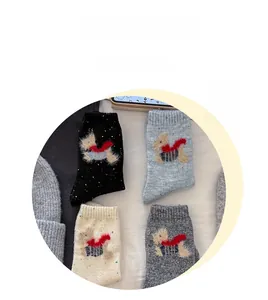 Detailed close-up of wool-blend socks featuring cute cartoon puppy embroidery with red scarves