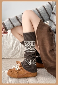 Close-up of vintage Fair Isle knit leg warmers in coffee brown with jacquard pattern