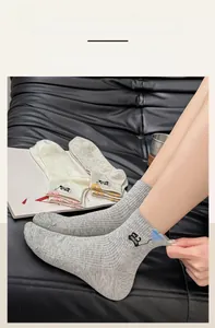 Close-up of elastic ribbed cuffs on cute embroidered cat socks in multiple soft colors