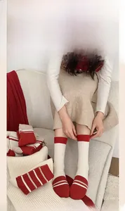 Detail of red and white striped cashmere wool socks with a cozy thick knitted texture