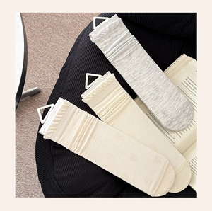 Detailed texture of breathable mesh silk socks with heart patterns in three colors