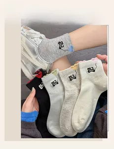 Close-up of ribbed cotton socks featuring cute cat embroidery and wavy heart cuffs