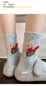 Detail of wool blend socks with cute dog 3D embroidery and colorful dot yarn texture