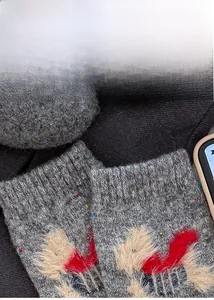 Detailed close-up of wool knit socks featuring a 3D faux fur cartoon dog pattern design