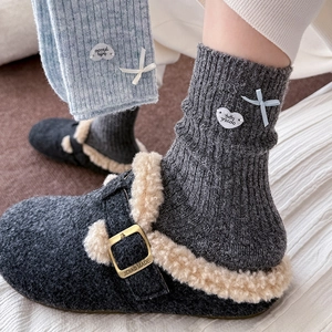Thick wool socks with bow and heart detail paired with warm fur-lined felt buckle clogs