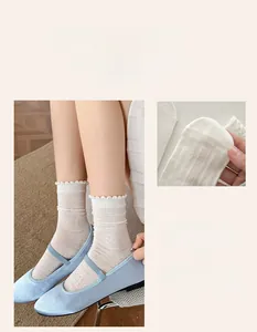 Détail de chaussettes en dentelle blanche avec des ballerines Mary Jane en satin bleu