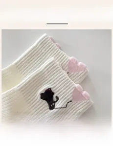 Detail of white cotton sock featuring high-elastic ribbed cuff and cute black cat embroidery