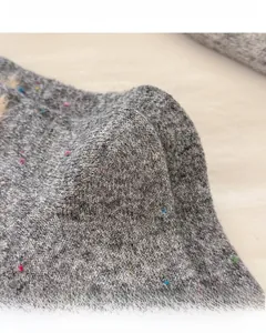 Detail of wool socks showing reinforced heel and toe with colorful speckled knit texture