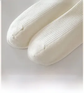 Detail shot of flat seamless toe and ribbed texture on white cotton socks