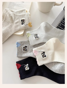 Detail of cute cat embroidery and vertical ribbed texture on colorful cotton crew socks