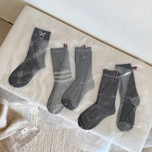 Five pairs of cotton crew socks with dog embroidery and stripe details in shades of grey